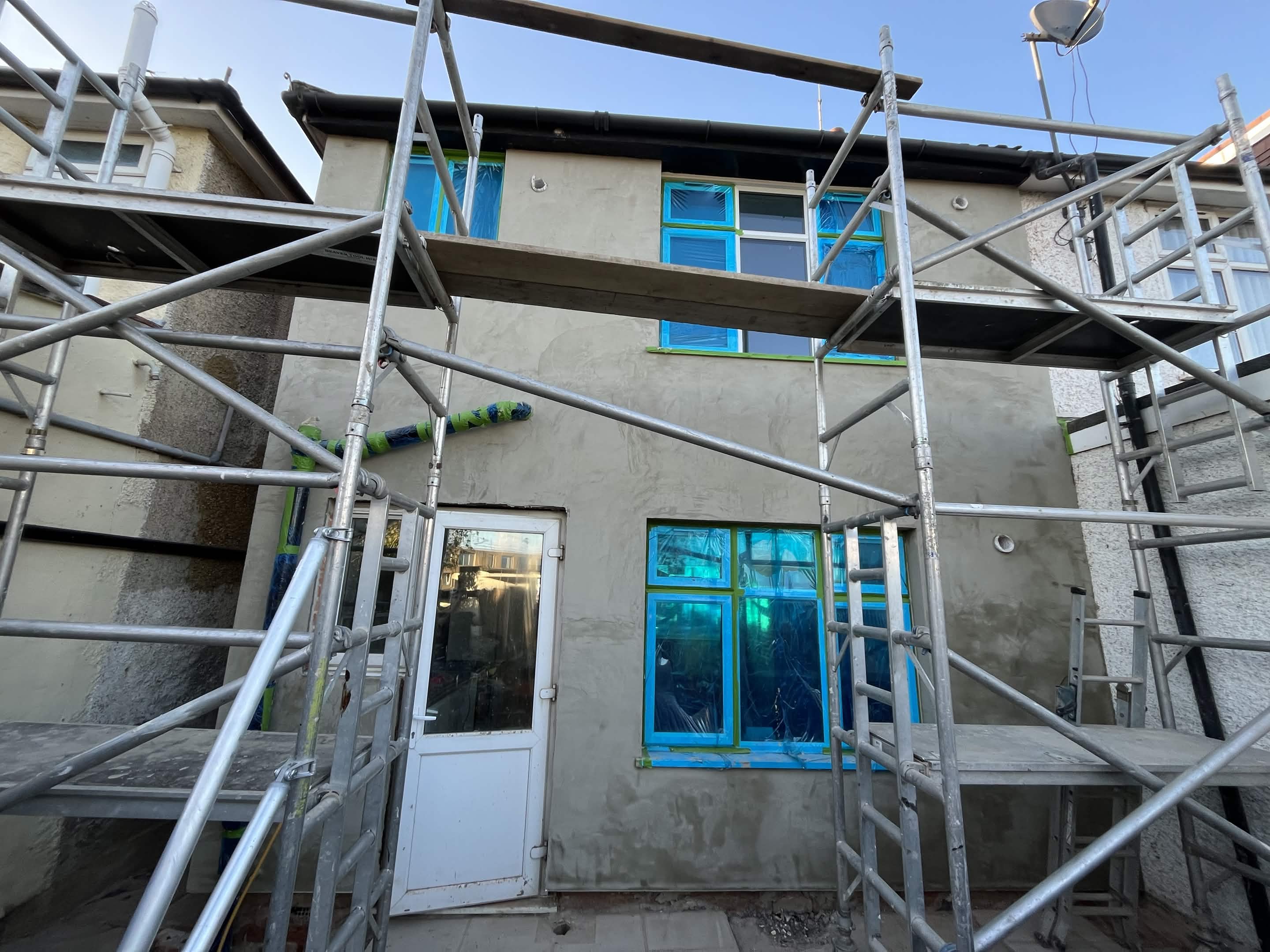 House No. 1 back elevation adhesive and reinforced layer stage