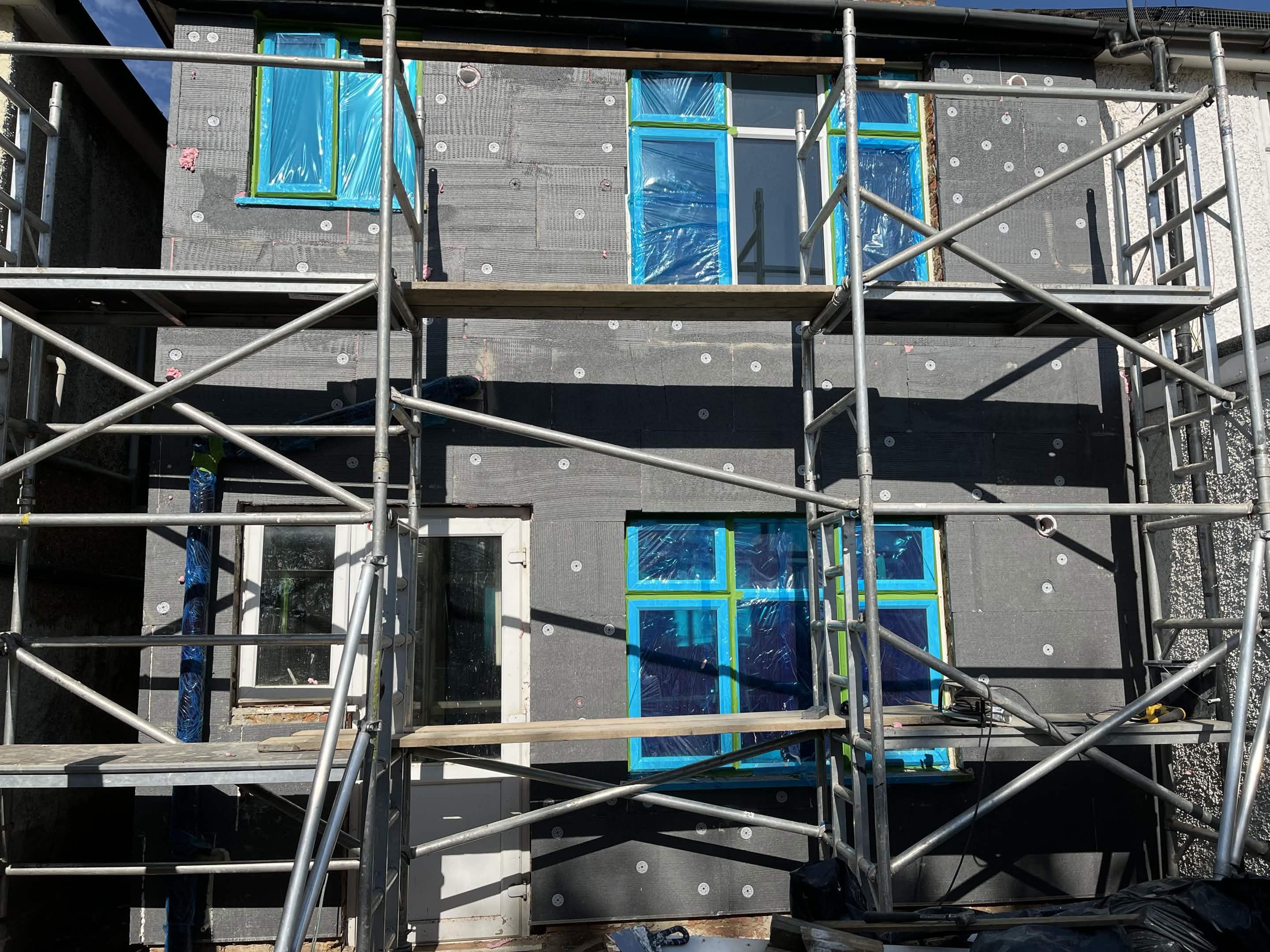 House No. 1 back elevation external insulation installation progress